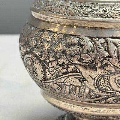 A South-East Asian repoussé silver teapot and a covered box — photo 9