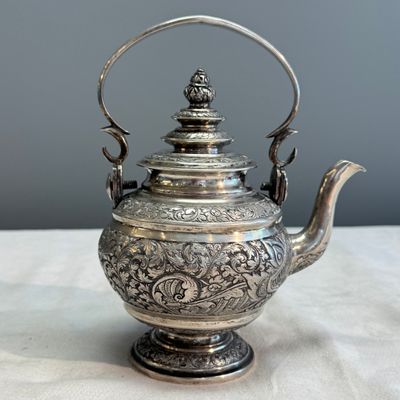 A South-East Asian repoussé silver teapot and a covered box — photo 11