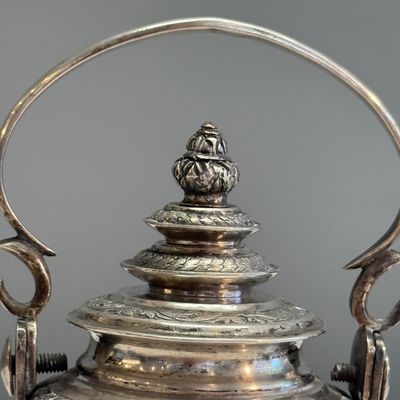 A South-East Asian repoussé silver teapot and a covered box — photo 13