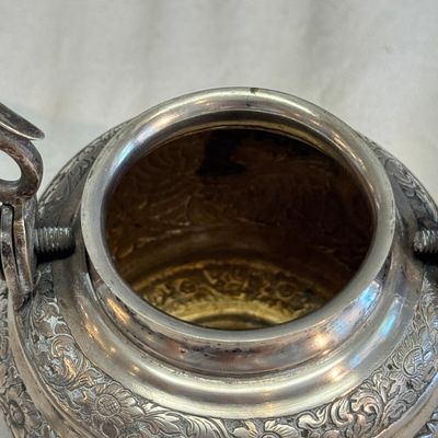 A South-East Asian repoussé silver teapot and a covered box — photo 17
