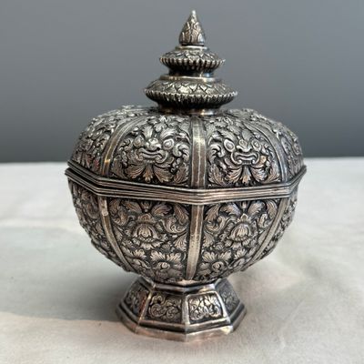 A South-East Asian repoussé silver teapot and a covered box — photo 26