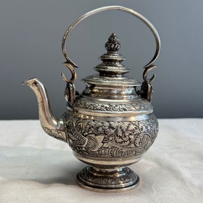 A South-East Asian repoussé silver teapot and a covered box — photo 2