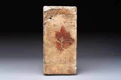 A Spanish cold-painted 'Socarrat' or ceiling tile with stylised floral design, 15th C.