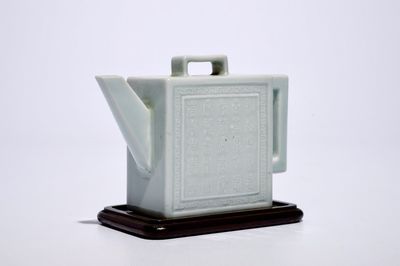 A square Chinese celadon glazed teapot with relief design, Qianlong mark, 19/20th C.