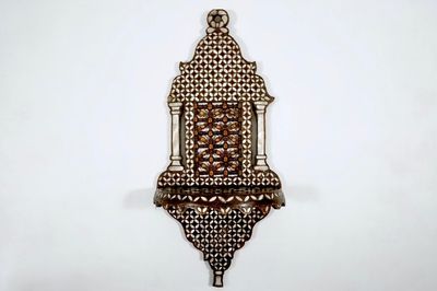 A Syrian wall bracket of wood inlaid with mother of pearl, 19/20th C.