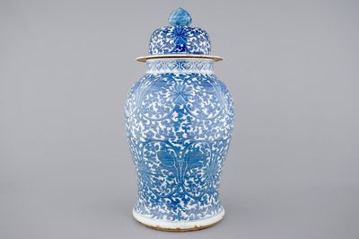 A tall blue and white Chinese porcelain vase and cover with lotus scrolls, 19th C.