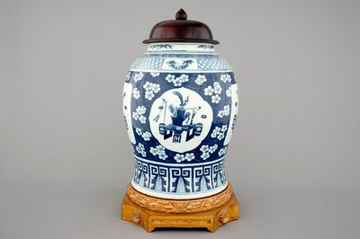 A tall Chinese blue and white porcelain temple jar on gilt wood stand, 19th C.