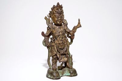 A tall Chinese gilt bronze figure with traces of polychromy, Ming