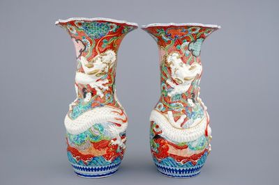A tall pair of Japanese relief-moulded dragon vases, 19th C.