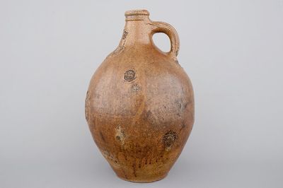 A tall Raeren saltglaze stoneware "Bartmann" or "Beardman" jug, early 17th C.