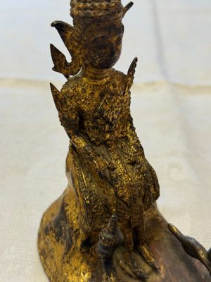 A Thai gilt-bronze figure of a seated deity with attendant animals, 19th C. — photo 6
