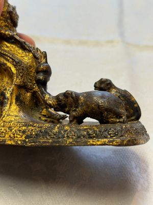 A Thai gilt-bronze figure of a seated deity with attendant animals, 19th C. — photo 7