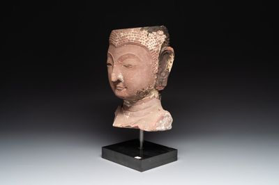 A Thai red sandstone head of Buddha, possibly Ayutthaya period, 15th C.