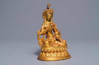 A Tibetan coral- and turquoise-inlaid gilt copper alloy figure of Tara, 19/20th C.