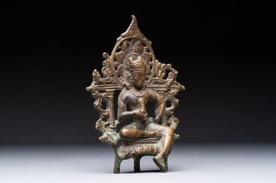 A Tibetan or Nepalese bronze seated Tara holding a vajra, 12/13th C.