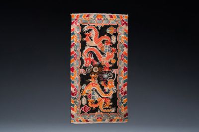 A Tibetan rug with two dragons chasing the pearl of wisdom, 19th C.
