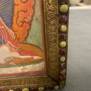 A Tibetan thangka in inlaid gilt brass frame, 19th C. — photo 10