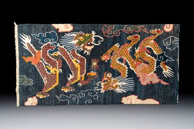 A Tibetan woollen ‘Dragons Chasing the Flaming Pearl’ carpet, 19th C.