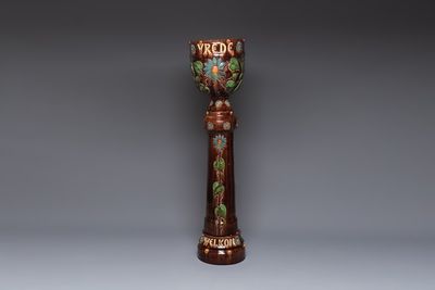A very large Art Nouveau Flemish pottery four-piece jardinière and stand, inscribed 'VREDE' and 'WELKOM', early 20th C.
