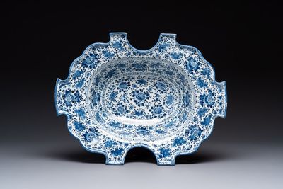 A very rare and large blue and white Dutch Delft double barber's bowl with floral design, late 17th C.