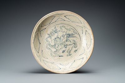 A Vietnamese or Annamese gilt-heightened blue, white and green dish with a Buddhist lion, 14/15th C.