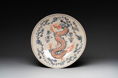 A Vietnamese or Annamese relief-molded blue, white and orange 'dragon' dish, 19th C.