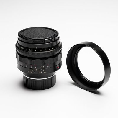 A Voigtländer Nokton 50 mm F1.1 lens and hood