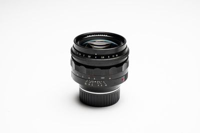 A Voigtländer Nokton 50 mm F1.1 lens and hood
