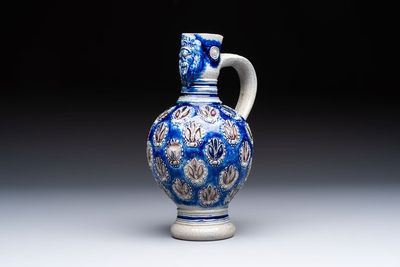 A Westerwald stoneware jug with a lion's head and moulded floral design, Germany, 17th C.