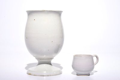 A white Dutch Delft drug jar on foot and a cup with ear, 18th C.