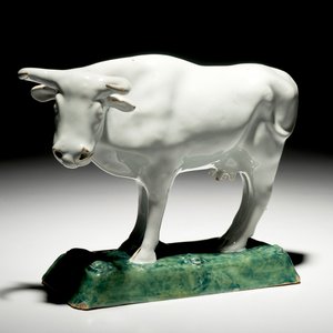 A white Dutch Delft model of a cow on a green base, 18th C. — 照片 1