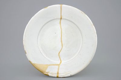 A white Dutch Delft plate with kintsugi style repair, 17th C.
