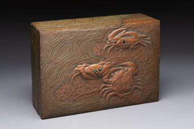 Alfred Daguet (Paris, 1875-1942): An Art Nouveau repoussé brass- and copper-mounted box with 'crabs' design and inset glass eyes, ca. 1900