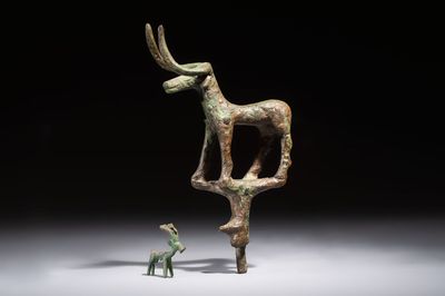 An Anatolian copper-alloy standard surmounted by a long-horned bull and a Luristan deer, 1st millennium BC.