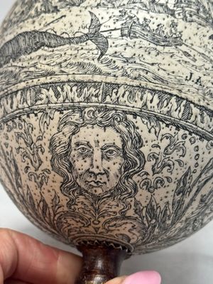 An engraved ostrich egg with a maritime scene on a wooden stand — photo 10