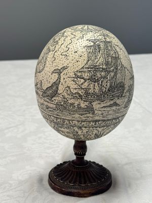 An engraved ostrich egg with a maritime scene on a wooden stand — photo 2