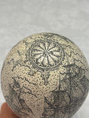 An engraved ostrich egg with a maritime scene on a wooden stand — photo 5