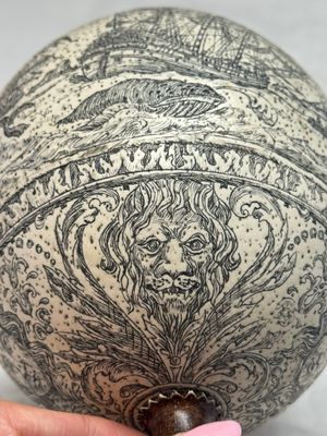 An engraved ostrich egg with a maritime scene on a wooden stand — photo 9