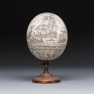 An engraved ostrich egg with a maritime scene on a wooden stand — photo 1