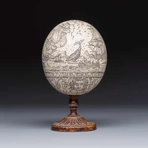 An engraved ostrich egg with a maritime scene on a wooden stand — photo 4