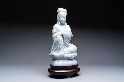 An exceptional and large Chinese carved pale lavender jadeite Guanyin on a wooden stand, Republic