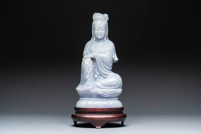 An exceptional and large Chinese carved pale lavender jadeite Guanyin on a wooden stand, Republic