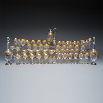 An extensive 53-piece French gilt-decorated 'Thistle Gold' crystal glass service with two decanter labels and a pair of candlesticks, St Louis, 20th C.