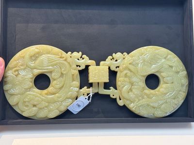 An imperial Chinese yellow jade 'dragon and phoenix' twin 'bi' disc, Qing — photo 1