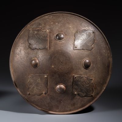 An Indo- Persian silver-damascened steel 'Dhal' shield with calligraphic design, 19th C.