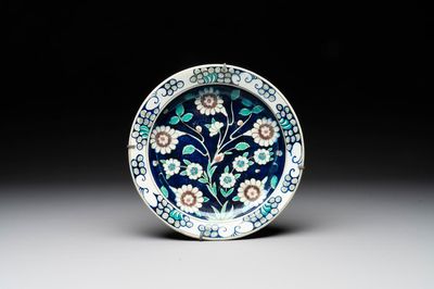An inscribed blue-ground Iznik-style dish, 19th C.