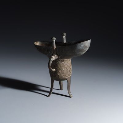 An inscribed Chinese archaistic bronze ritual wine vessel, Jue, 20th C.