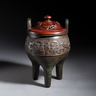An inscribed Chinese archaistic bronze tripod incense burner with hongmu cover, Ming