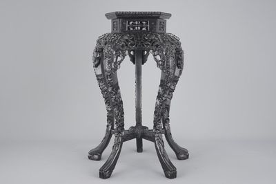 An intricately carved Chinese hardwood marble top vase stand, 19th C.
