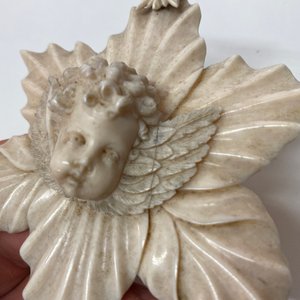 An ivory Christ medallion and a winged cherub's head on floral ground, probably France, late 18th C. and ca. 1900 — photo 4
